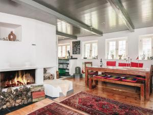 a living room with a fireplace and a table at Home with Spa and Fireplace in Fanø