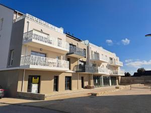 a building with balconies on the side of it at Sea View Family Stay in Plouarzel in Plouarzel