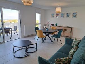 a living room with a couch and a table at Sea View Family Stay in Plouarzel in Plouarzel