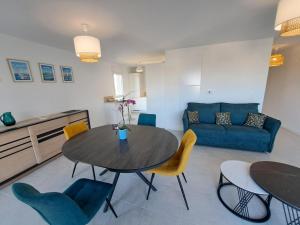 a living room with a table and chairs and a couch at Sea View Family Stay in Plouarzel in Plouarzel +22 photos
