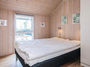 a large bed in a room with a window at 8 person holiday home in Tarm in Tarm