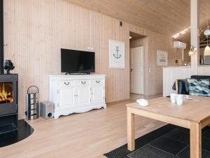 a living room with a tv and a fireplace at 8 person holiday home in Tarm in Tarm