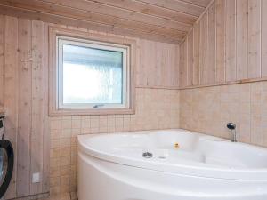 a white tub in a bathroom with a window at 8 person holiday home in Tarm in Tarm +27 photos