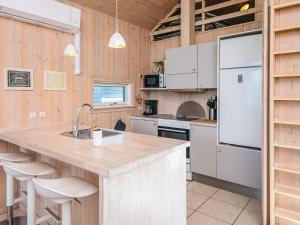 a kitchen with a counter and a refrigerator at 8 person holiday home in Tarm in Tarm