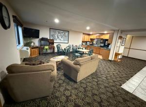 a living room with two couches and a table at Dodgeville inn & suites in Dodgeville