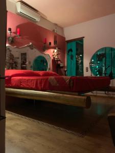 a bedroom with a large bed with red sheets at La Gata Negraa in Bácor +37 photos