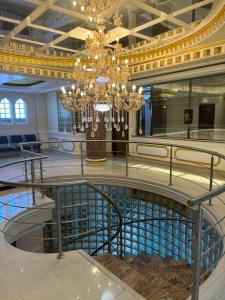 a large lobby with a chandelier and a pool at Hotel Troya in Ibarra