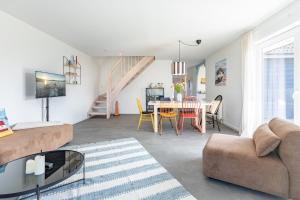 a living room with a couch and a table at Cottage am Deich Whg Mareile in Uelvesbüll