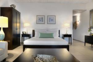 una camera da letto con un grande letto bianco e un divano di Carlisle Bay a Old Road Altre 37 foto