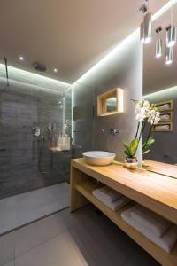 a bathroom with a sink and a shower at Arkadia Hotel in Kypseli