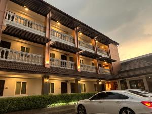 a white car parked in front of a building at The Lion King Hotel by Thai Baan Ozone Udonthani in Udon Thani +28 photos