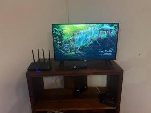 a flat screen tv sitting on top of a wooden stand at Villa Cali PASO in Sambava