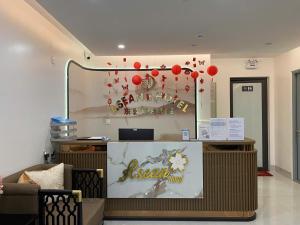 a restaurant with a reception desk with red balloons at ASEAN MINH NGUYỆT Hotel in Nhân Mỹ