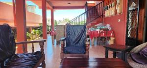 a living room with a staircase and a red wall at Villa Cali SONOMA in Sambava