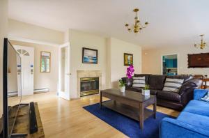 a living room with a couch and a table at Bright and Spacious Upper Level House, Great Area in North Vancouver