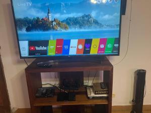 a flat screen tv sitting on top of a wooden table at Villa CALI Napa in Sambava