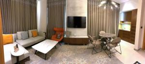 a living room with a couch and a table at Oscar Apartments in Cairo