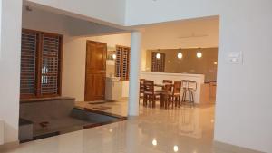 a kitchen and dining room with a table and chairs at Santhosh Villa in Thanjāvūr +31 photos