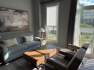 a living room with a couch and chairs and a table at Spacious New 3BR Townhome Walking to Falls in Niagara Falls