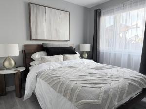 a bedroom with a large bed and a window at Spacious New 3BR Townhome Walking to Falls in Niagara Falls