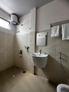 a bathroom with a sink and a toilet at The View Hotel Falkland in Āīzawl
