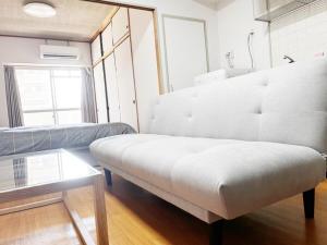 a living room with a couch and a table at Crest YS chiyoda 4B in Aoichō