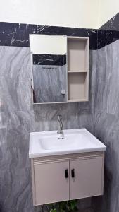 a bathroom with a white sink and a mirror at Pink Kangaroo Bungalows in Ko Kood +53 photos