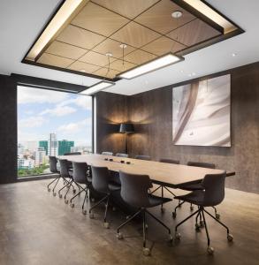 a conference room with a long table and chairs at One Residence Hotel & Apartment in Phnom Penh +84 photos