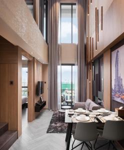 a living room with a table and chairs in a room at One Residence Hotel & Apartment in Phnom Penh