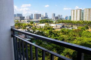a balcony with a view of a city at Cozy 619 1BR Shore2 Residence, Near Airport, IKEA, MOA, SMX, Pasay City, Manila in Manila