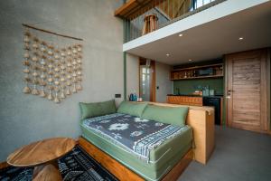 a living room with a couch and a table at Black Wood Cabin in Kintamani