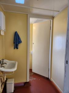 a bathroom with a sink and a white door at Hotel Cecil Wondai in Wondai +17 photos