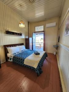 a bedroom with a large bed in a room at Hotel Cecil Wondai in Wondai