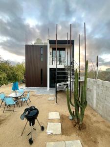 a house with a cactus and a grill in front of it at Casa Campamento in La Cueva
