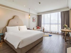 a bedroom with a large bed and a large window at Mercure Beijing City Center in Beijing +52 photos