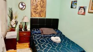 a bedroom with a bed with a blue comforter at Refuge Appartement in Montreal