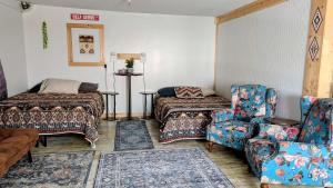 a living room with a couch and a bed and a chair at Geraldton Rooms Unit D in Geraldton