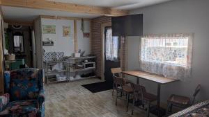 a living room with a table and chairs at Geraldton Rooms Unit D in Geraldton