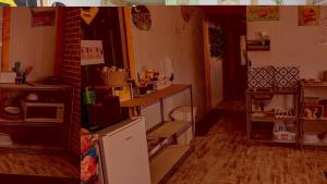 a kitchen with a refrigerator and a counter in a room at Geraldton Rooms Unit D in Geraldton