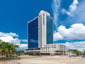 a tall building with a lot of windows at Mercure Danzhou Yangpu Seaview in Dongshan