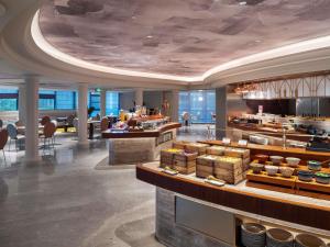 a restaurant with a buffet in a building at Mercure Luoyang Downtown in Luoyang