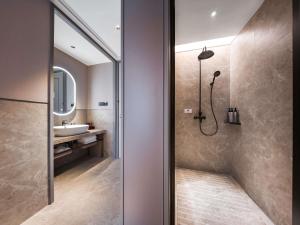 a bathroom with a shower and a sink at Mercure Xi'an New Software City in Xi'an +84 photos