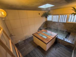 an overhead view of a bathroom with a tub at Shiraho Breeze Poolside Villa in Ishigaki Island