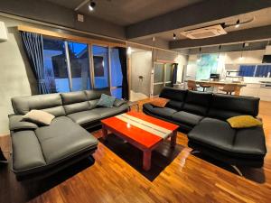a living room with a couch and a coffee table at Shiraho Breeze Poolside Villa in Ishigaki Island