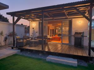 a pergola on a deck in a backyard at Shiraho Breeze Poolside Villa in Ishigaki Island