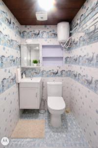 a bathroom with a toilet and a sink at Chouhan Resort in Katihār