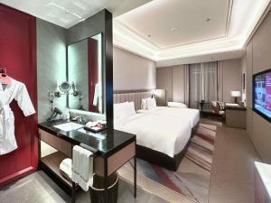 a hotel room with a bed and a mirror at Mövenpick by Accor Shanghai People's Square in Shanghai