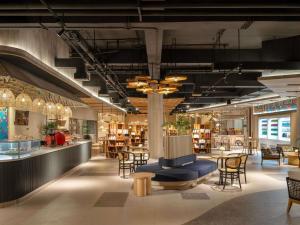 a store with chairs and tables and a library at Mövenpick Resort & Spa Bintan Lagoon in Lagoi