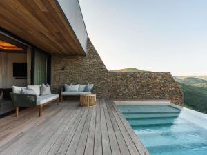 a house with a swimming pool and a wooden deck at Mantis Hiddn in Addo in Addo