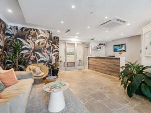 a living room with a couch and a table at The Sebel Byron Bay in Byron Bay
